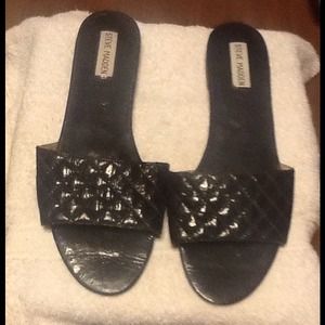 Steve Madden black patent leather slide sandals.
