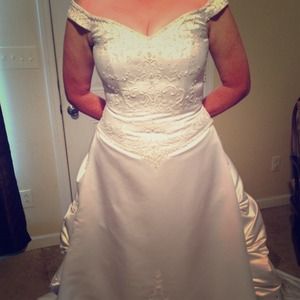Off-the-shoulder satin wedding gown.