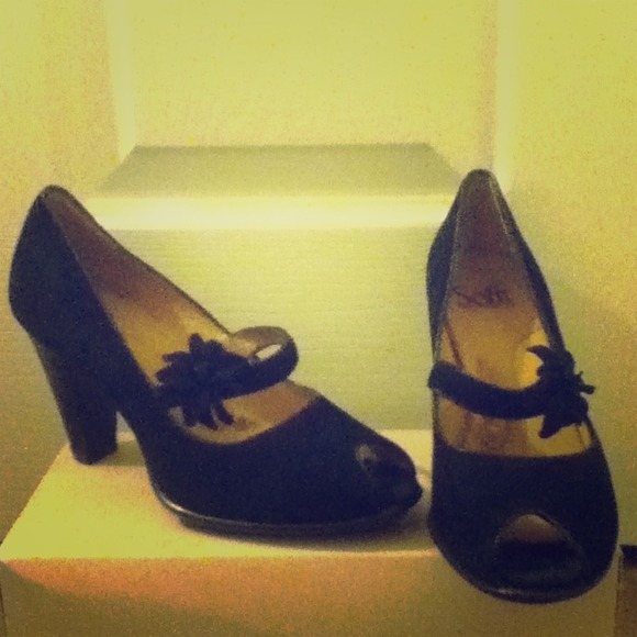 Black peep toe shoes with a flower detail strap.