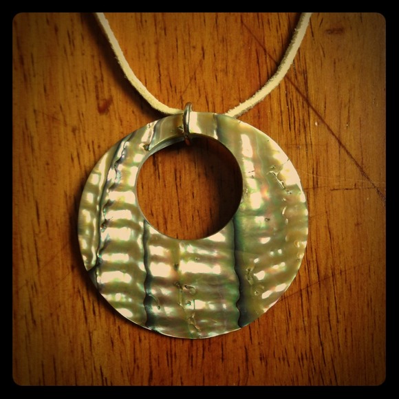 Hand-carved shell pendant on suede necklace