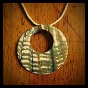 Hand-carved shell pendant on suede necklace