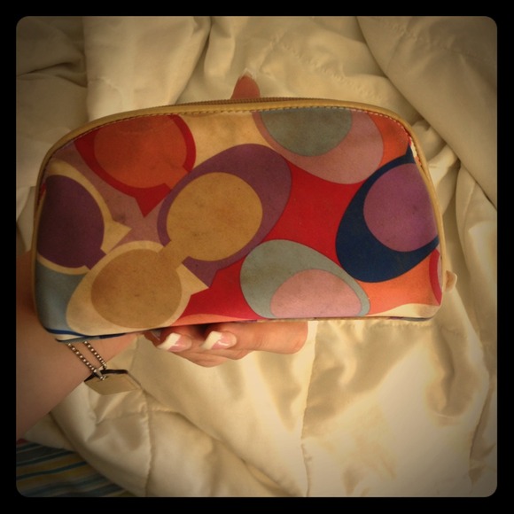 A travel sized coach makeup bag