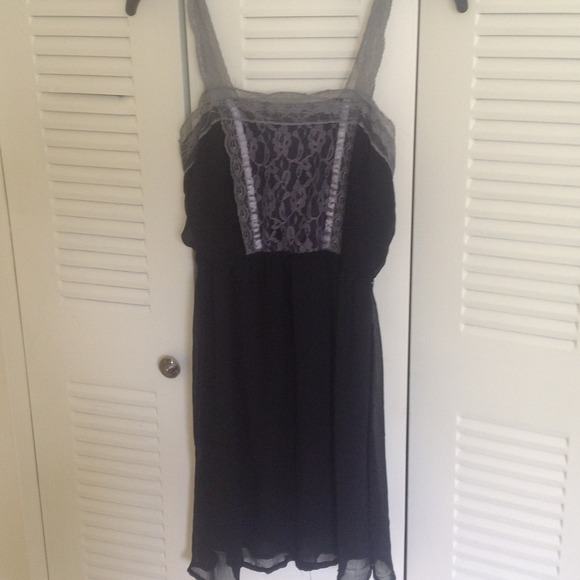 A black lace dress with grey lacing on it