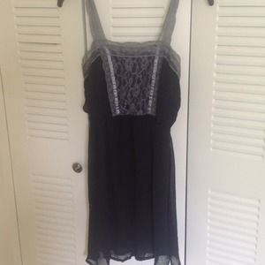 A black lace dress with grey lacing on it