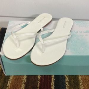 White flip flops. Never worn!