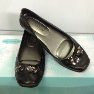 Black flats with toe embellishments.
