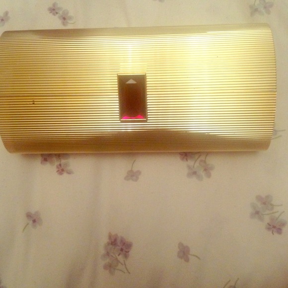 Gold Estée Lauder cosmetics clutch