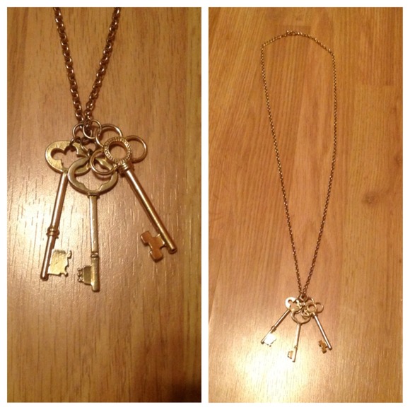 Cute gold necklace with key charm.