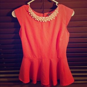 Coral peplum top with pearl collar