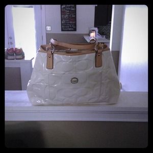 White coach purse with tag.