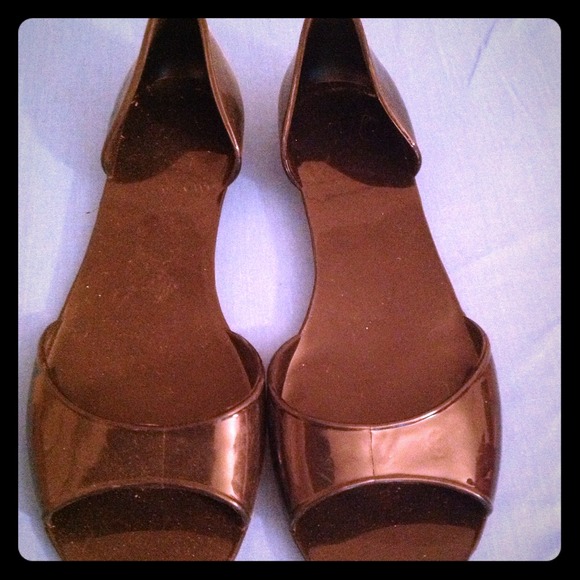 Black open-toed "jelly" flats.