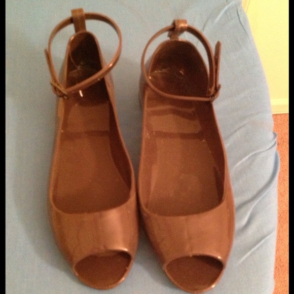 Brown open-toed "jelly" flats with ankle strap