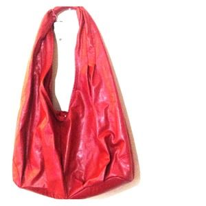 Burgundy hobo style bag with snap closure.