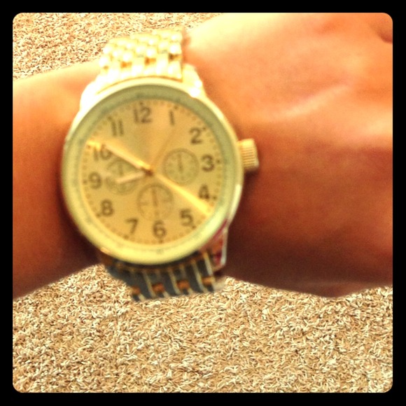 Gold colored big faced watch