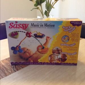 Crib mobile and little dress . Trade with jonreen