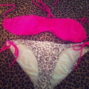 Pink bikini top and leopard bottoms .