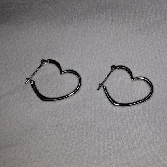 Sterling silver heart shaped hoop earrings.