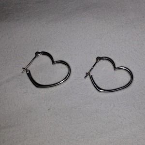 Sterling silver heart shaped hoop earrings.