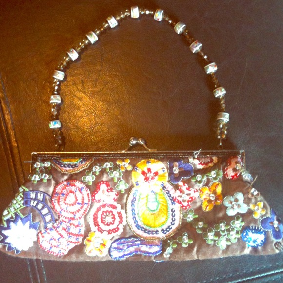 Beaded and hand-stitched clutch