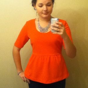 Coral peplum top with a 3/4 sleeve