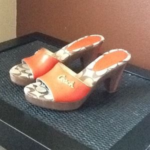 stylish short healed coach shoes. Burn orange.