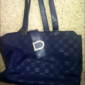 A DKNY hand bag with a little wear on the strap