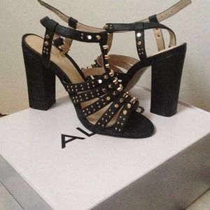 Chunky heeled black leather sandals.