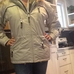 Tan snow jacket with hood.