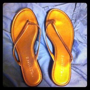 Kim Rogers gold flip flops