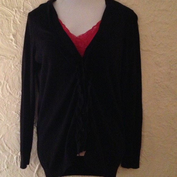 Black sweater with v neck. Buttons and ruffles
