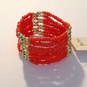 Beautiful orange bracelet with gold accents