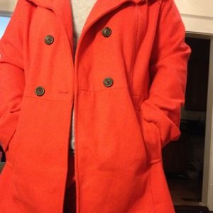 Orange knee length coat. NWOT.