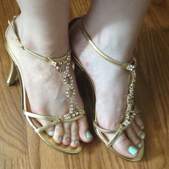 Gold strappy heels with rhinestones.