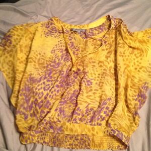 Yellow and purple "flowy" JLo top.