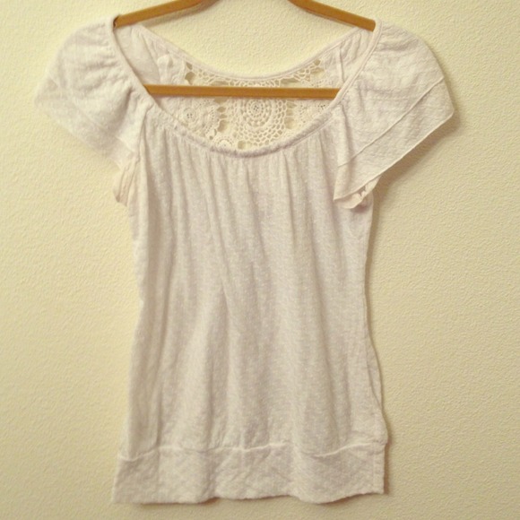 Cute white top with crochet design on back.