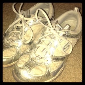 Sketchers sport white and silver shoes
