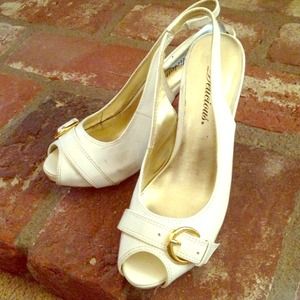 White peep toe heels. With gold buckle.