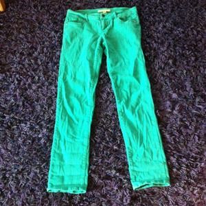 Jade green stretch skinny jeans with golden studs