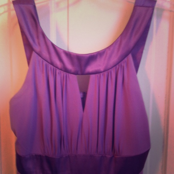 Cocktail length purple dress.