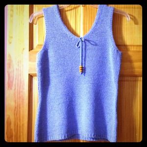Blue sleeveless sweater with bow in front.