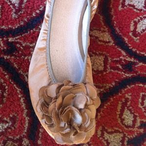 Gold ballet flats with flower embellishment
