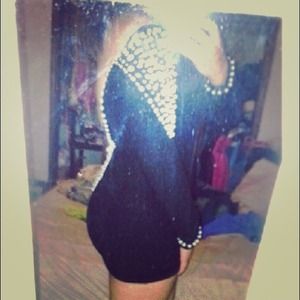 Mini black dress w/ pearl accents and an open back