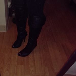 Over the knee, heeled open toe boot.