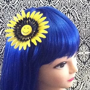 Yellow &black smiley face hair flair flower.