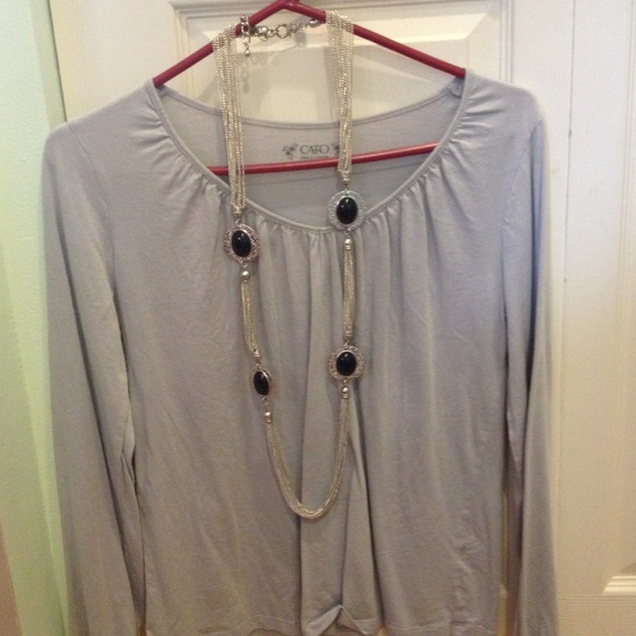 Long silver a d black necklace.