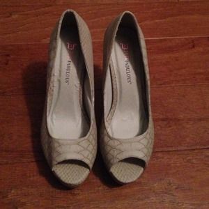 Size 7.5 snake print pumps.