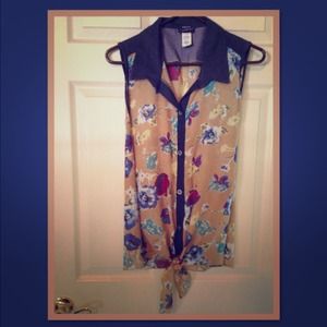 Cute, sheer sleeveless blouse.