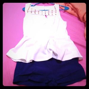 White top and blue shorts