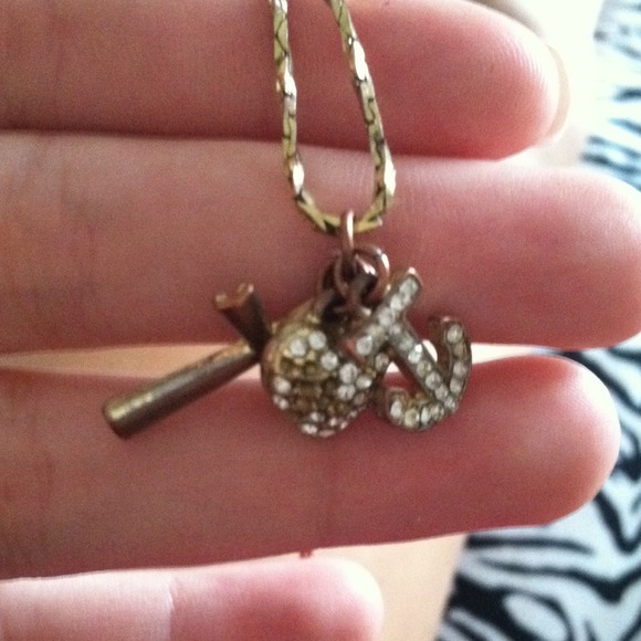 Cross , heart , & anchor gold necklace .