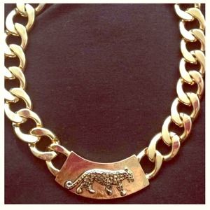 Gold chain with cheetah faceplate.